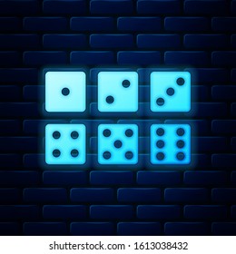 Glowing neon Set of six dices icon isolated on brick wall background.  Vector Illustration