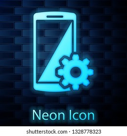 Glowing neon Setting on smartphone screen icon on brick wall background. Mobile phone and gear sign. Adjusting app, set options, repair, fixing phone concepts. Vector Illustration