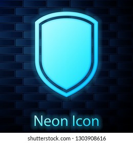 Glowing neon Shield icon isolated on brick wall background. Guard sign. Vector Illustration