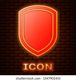 Glowing neon Shield icon isolated on brick wall background. Guard sign.  Vector Illustration