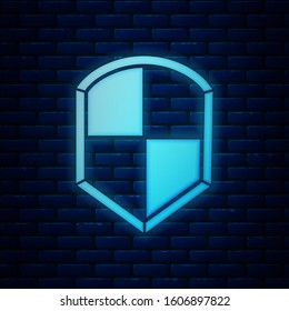 Glowing neon Shield icon isolated on brick wall background. Guard sign. Security, safety, protection, privacy concept.  Vector Illustration