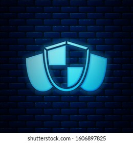 Glowing neon Shield icon isolated on brick wall background. Guard sign. Security, safety, protection, privacy concept.  Vector Illustration