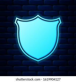 Glowing neon Shield security icon isolated on brick wall background. Protection, safety, security concept. Firewall access privacy sign.  Vector Illustration