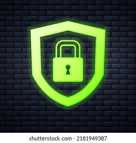 Glowing neon Shield security with lock icon isolated on brick wall background. Protection, safety, password security. Firewall access privacy sign.  Vector