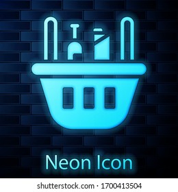 Glowing neon Shopping basket and food icon isolated on brick wall background. Food store, supermarket. Vector Illustration
