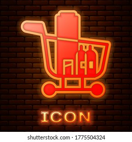 Glowing neon Shopping cart and food icon isolated on brick wall background. Food store, supermarket. Vector Illustration