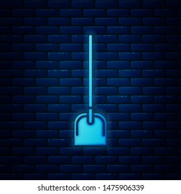 Glowing neon Shovel icon isolated on brick wall background. Gardening tool. Tool for horticulture, agriculture, farming.  Vector Illustration