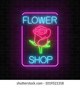 Glowing Neon Sign Of Flower Shop In Rectangle Frame On Dark Brick Wall Background. Design Of Floral Store Signboard. Street Lights Advertisement. Vector Illustration.