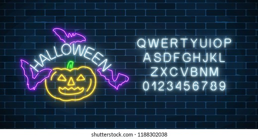 Glowing neon sign of halloween invitation banner with alphabet on dark brick wall background. Bright halloween night sign with pumpkin and bats in neon style. Vector illustration.