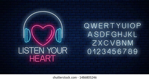 Glowing neon sign with headphones, heart shape and listen your heart slogan with alphabet on dark brick wall background. Call to listen symbol with cheering inscription. Vector illustration.