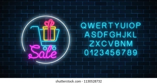 Glowing neon sign of supermarket shopping cart with gift box and alphabet on a dark brick wall background. Luminous advertising sale banner. Neon light effects store basket. Vector illustration.