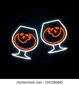 Glowing neon sign with two clinking cognac, rum or bourbon glasses. Vector isolated illustration. Icon for night bar background. Led luminous signboard for pub.