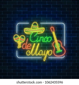 Glowing neon sinco de mayo holiday sign in rectangle frame on dark brick wall background. Mexican festival flyer.