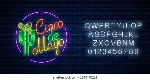 Glowing neon sinco de mayo holiday sign with alphabet in circle frame on dark brick wall background. Mexican festival flyer design with cactus and sombrero hat. Vector illustration.