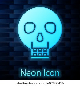 Glowing neon Skull icon isolated on brick wall background. Happy Halloween party.  Vector Illustration