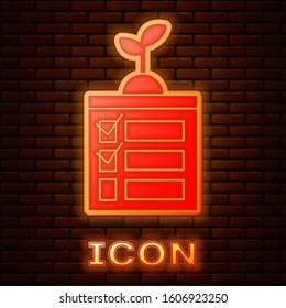 Glowing neon Smart farming technology - timer farm automation system in app icon isolated on brick wall background.  Vector Illustration