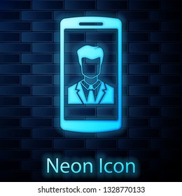 Glowing neon Smartphone with contact on screen icon isolated on brick wall background. Incoming call. Human on phone screen. Call contact. Vector Illustration