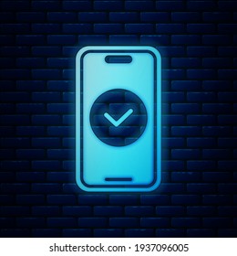 Glowing neon Smartphone, mobile phone icon isolated on brick wall background.  Vector