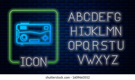 Glowing neon Smartphone and playing in game icon isolated on brick wall background. Mobile gaming concept. Neon light alphabet. Vector Illustration