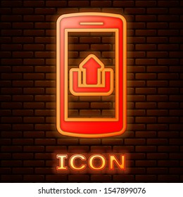 Glowing neon Smartphone with upload icon isolated on brick wall background.  Vector Illustration