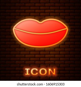 Glowing neon Smiling lips icon isolated on brick wall background. Smile symbol.  Vector Illustration