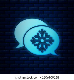 Glowing neon Snowflake with speech bubble icon isolated on brick wall background. Merry Christmas and Happy New Year.  Vector Illustration