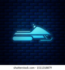 Glowing neon Snowmobile icon isolated on brick wall background. Snowmobiling sign. Extreme sport.  Vector Illustration