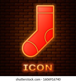 Glowing neon Socks icon isolated on brick wall background.  Vector Illustration