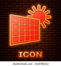 Glowing neon Solar energy panel and sun icon isolated on brick wall background.  Vector Illustration