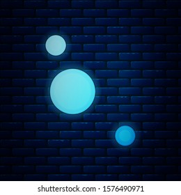 Glowing neon Solar system icon isolated on brick wall background. The planets revolve around the star.  Vector Illustration