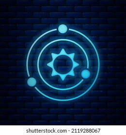 Glowing neon Solar system icon isolated on brick wall background. The planets revolve around the star.  Vector