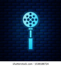 Glowing neon Spatula icon isolated on brick wall background. Kitchen spatula icon. BBQ spatula sign. Barbecue and grill tool.  Vector Illustration