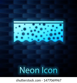 Glowing neon Sponge with bubbles icon isolated on brick wall background. Wisp of bast for washing dishes. Cleaning service logo.  Vector Illustration