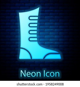 Glowing neon Sport boxing shoes icon isolated on brick wall background. Wrestling shoes. Vector