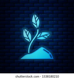 Glowing neon Sprout icon isolated on brick wall background. Seed and seedling. Leaves sign. Leaf nature.  Vector Illustration