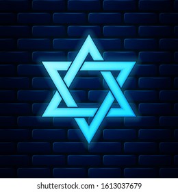 Glowing neon Star of David icon isolated on brick wall background. Jewish religion symbol.  Vector Illustration