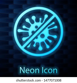 Glowing neon Stop virus, bacteria, germs and microbe icon isolated on brick wall background. Antibacterial and antiviral defence, protection infection.  Vector Illustration