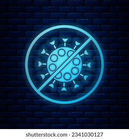 Glowing neon Stop virus icon isolated on brick wall background. Corona virus 2019-nCoV. Bacteria and germs, cell cancer, microbe, fungi.  Vector Illustration