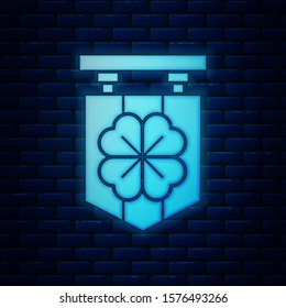 Glowing neon Street signboard with four leaf clover icon isolated on brick wall background. Suitable for advertisements bar, cafe, pub.  Vector Illustration