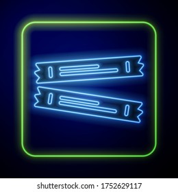 Glowing neon Sugar stick packets icon isolated on blue background. Blank individual package for bulk food products as coffee, salt, spices.  Vector
