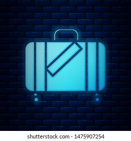 Glowing neon Suitcase for travel and stickers icon isolated on brick wall background. Traveling baggage sign. Travel luggage icon.  Vector Illustration