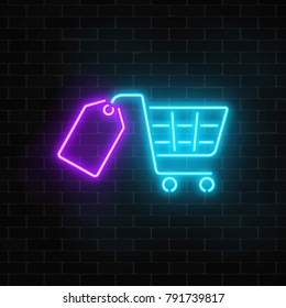 Glowing neon supermarket shopping cart with tag sign on a dark brick wall background. Luminous advertising signboard. Neon light effects store basket. Vector illustration.