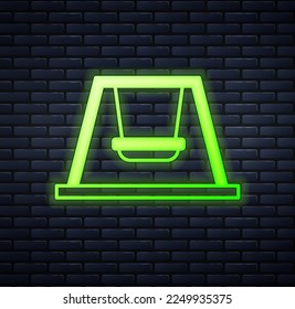 Glowing neon Swing for kids summer games on playground icon isolated on brick wall background. Outdoor entertainment equipment.  Vector