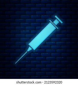 Glowing neon Syringe icon isolated on brick wall background. Syringe for vaccine, vaccination, injection, flu shot. Medical equipment.  Vector Illustration