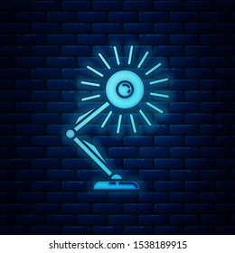 Glowing neon Table lamp icon isolated on brick wall background. Table office lamp.  Vector Illustration