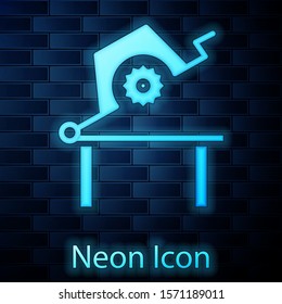 Glowing neon Table saw for woodwork icon isolated on brick wall background. Power saw bench.  Vector Illustration