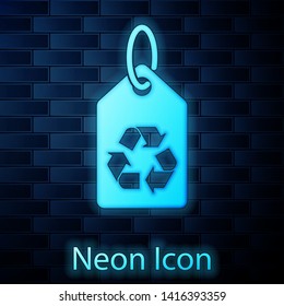 Glowing neon Tag with recycle symbol icon isolated on brick wall background. Banner, label, tag, logo, sticker for eco green. Vector Illustration