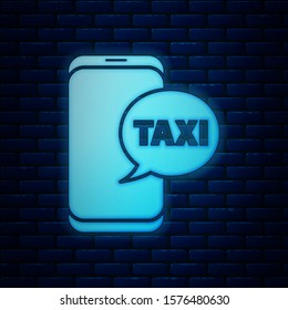 Glowing neon Taxi call telephone service icon isolated on brick wall background. Taxi for smartphone.  Vector Illustration