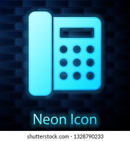 Glowing neon Telephone icon isolated on brick wall background. Landline phone. Vector Illustration