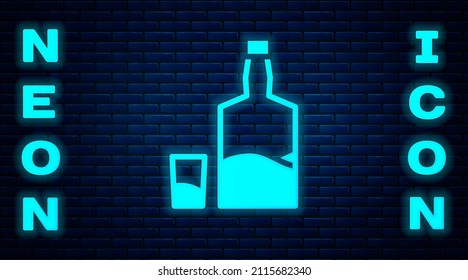 Glowing neon Tequila bottle and shot glass icon isolated on brick wall background. Mexican alcohol drink.  Vector